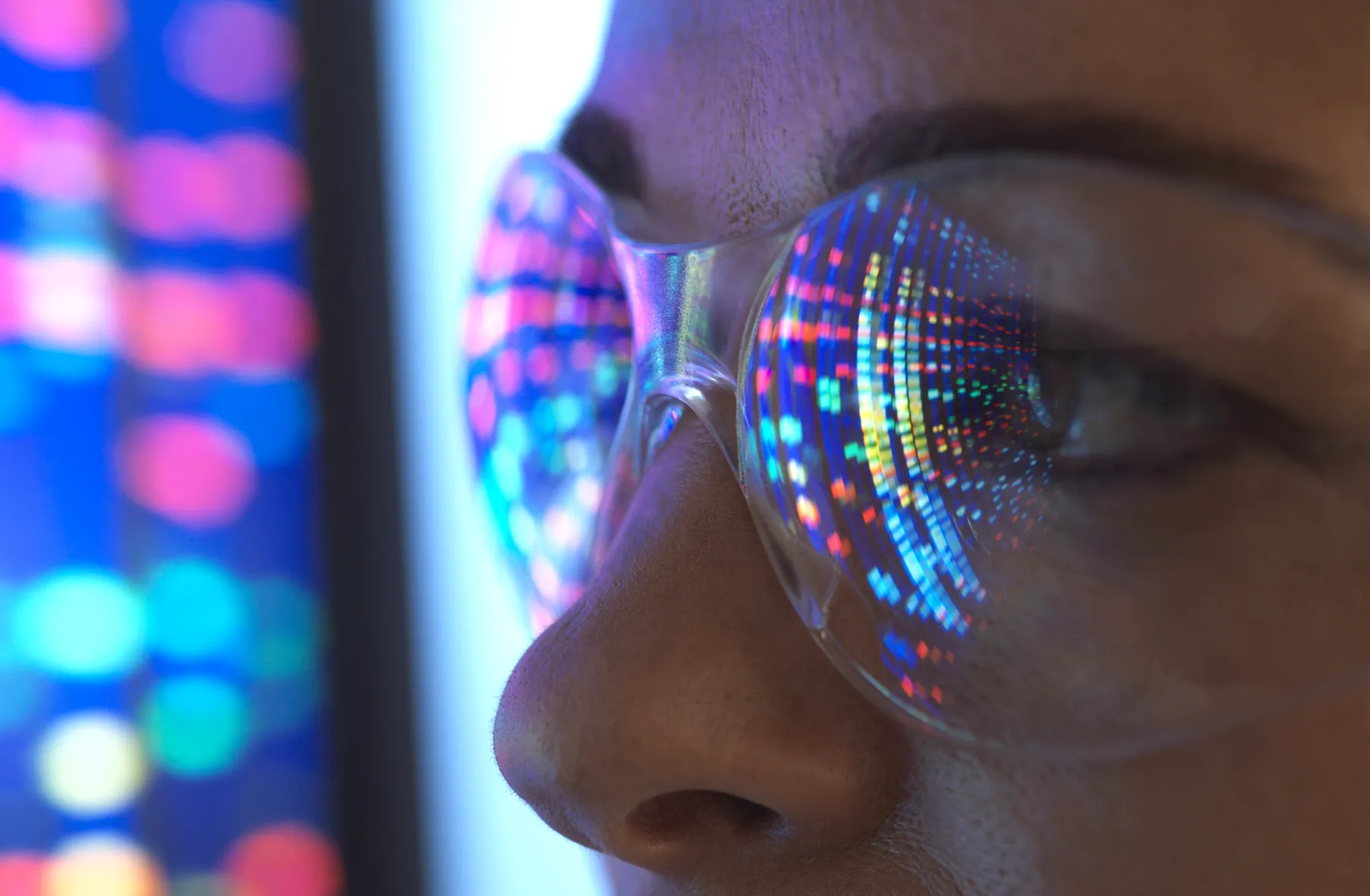 Close-up of scientist with a screen reflected in eyeglasses